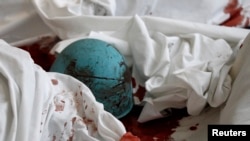 The helmet of a dead antigovernment protester lies on bloody sheets in the lobby of the Hotel Ukraine.