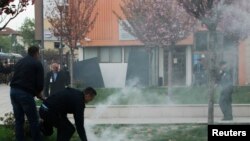 Kosovo -- Protesters firing tear gas disrupt the inauguration ceremony for new President Hashim Thaci in Pristina, April 8, 2016