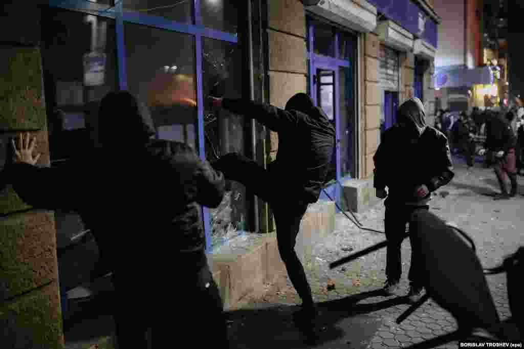 Protesters smash the windows of a political office in Sofia.