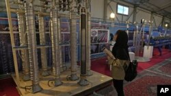A student looks at Iran's domestically built centrifuges in an exhibition of the country's nuclear achievements in Tehran in February 2023.