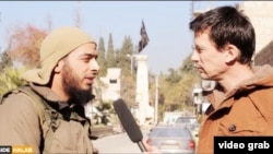 A screen shot from a video showing a French Islamic State militant (left) talking to British hostage John Candlie