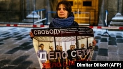 A single-picket protester in Moscow holds a poster in support of a group of men who were given lengthy prison sentences in a case known as "the Network." The verdicts against the men who were found guilty of terrorism charges has drawn widespread criticism both in Russia and abroad. 