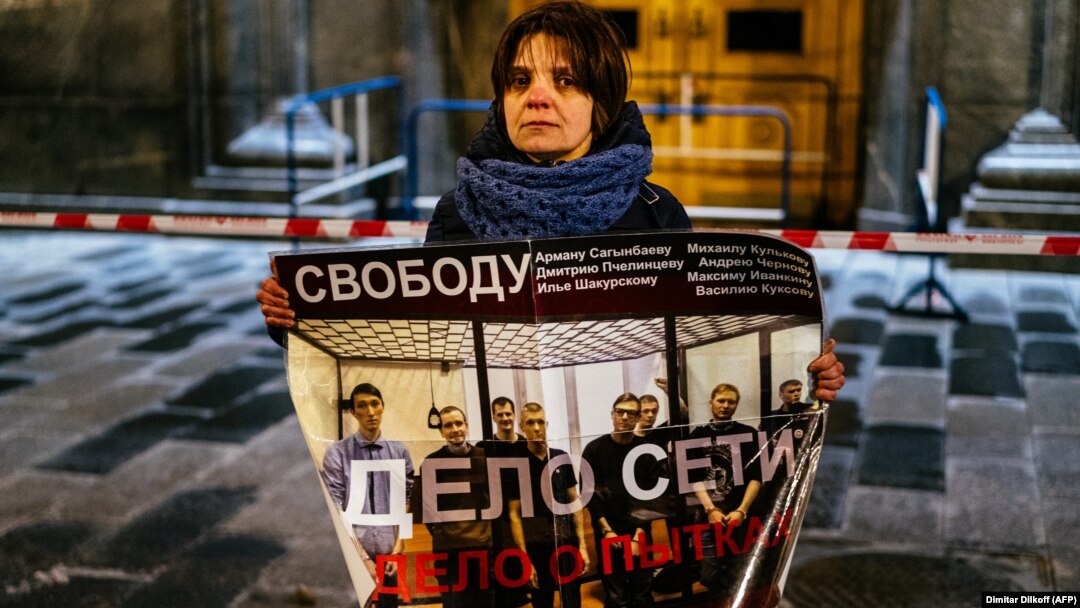 A single-picket protester in Moscow holds a poster in support of a group of men who were given lengthy prison sentences in a case known as "the Network." The verdicts against the men who were found guilty of terrorism charges has drawn widespread criticism both in Russia and abroad. 