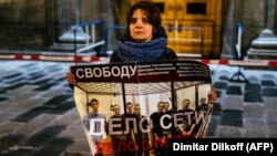 A single-picket protester in Moscow holds a poster in support of a group of men who were given lengthy prison sentences in a case known as "the Network." The verdicts against the men who were found guilty of terrorism charges has drawn widespread criticism both in Russia and abroad. 