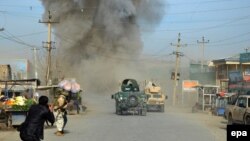 FILE: Smoke billows from the scene of a suicide bomb blast that targeted a police headquarters in Kunduz, February, 2015.