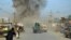 FILE: Smoke billows from the scene of a suicide bomb blast that targeted a police headquarters in Kunduz, February, 2015.