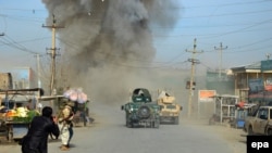 Smoke billows from the scene of a suicide bomb blast that targeted the police headquarters in Kunduz on February 10.