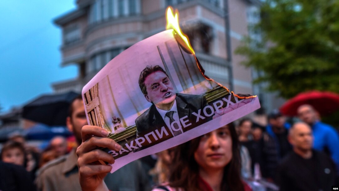 A protestor burns a picture of Macedonia's former Prime Minister Nikola Gruevski. The Balkan country has been in political turmoil since February 2015 over a wiretapping scandal.
