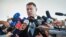 Romanian President Klaus Iohannis speaks to reporters after casting his ballot at a polling station in Bucharest on November 10.