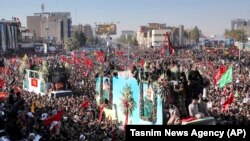 Iran -- Coffins of Gen. Qassem Soleimani and others who were killed by a U.S. drone strike are carried on a truck surrounded by mourners during a funeral procession in Kerman, January 7, 2020.