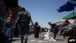 FILE : Afghan policemen investigate at the site of a suicide bomb attack in the northern Balkh province.