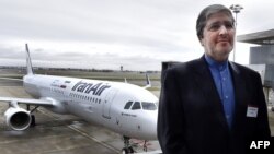 France -- Chief executive officer of Iran Air Farhad Parvaresh poses in front of an Airbus A321 bearing the logo of Iran Air at the Airbus delivery center, in Colomiers, January 11, 2017