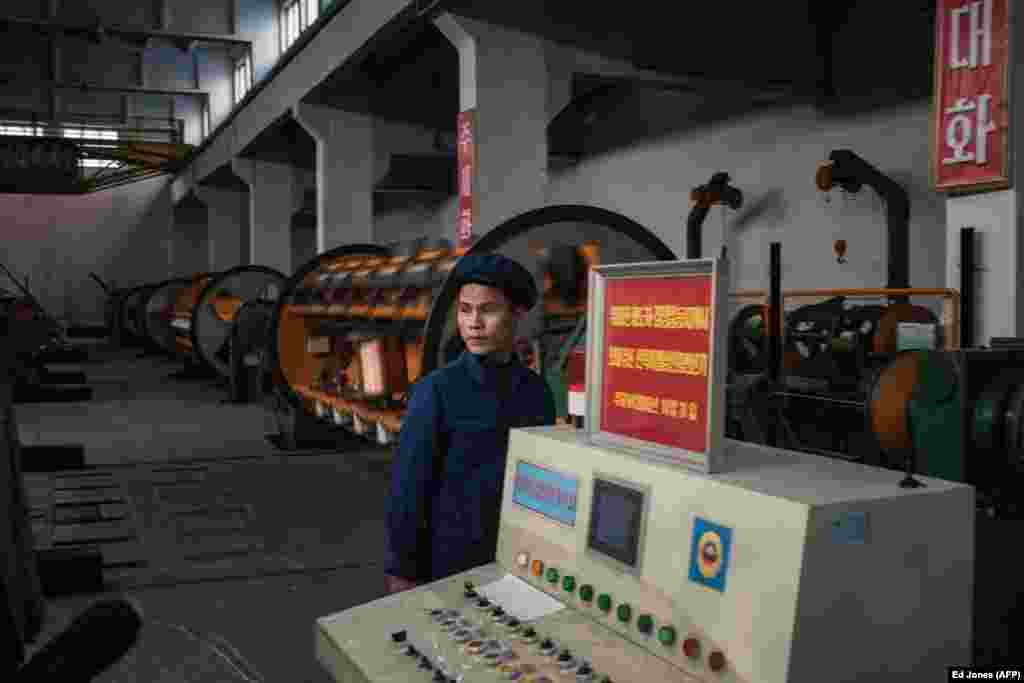 A worker photographed during a media tour of an Electric Cable Factory. Factories in the capital which produce more than their quota can now sell the excess production, offer workers bonuses, or reinvest the money.&nbsp;