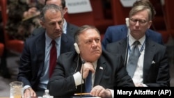 U.S. -- U.S. Secretary of State Mike Pompeo adjusts his tie during a Security Council meeting on Iran's compliance with the 2015 nuclear agreement, at United Nations headquarters in New York, December 12, 2018