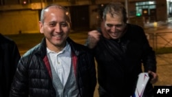 Kazakh opposition figure and oligarch Mukhtar Ablyazov (left), flanked by his lawyers, leaves the Fleury-Merogis jail near Paris after being released on December 9.
