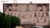 A billboard depicting Iranian spiritual leaders, top right, and volunteer fighters from the Iran-backed Popular Mobilization Forces who were killed in Iraq fighting Islamic State militants, is displayed in Basra, March 31, 2018