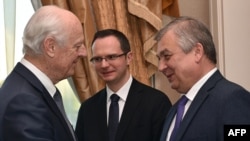 UN special envoy for Syria Staffan de Mistura (left) greets Russian mediator Aleksandr Lavrentyev as they attend the fourth round of Syria peace talks in Astana on May 3.