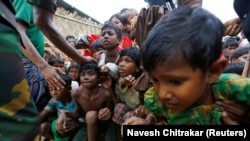 BANGLADESH -- Rohingya refugee children struggle as they wait to receive food outside the distribution center at Palong Khali refugee camp near Cox's Bazar, Bangladesh, November 17, 2017.