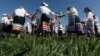 Members of the Mizhrechcha folk ensemble perform a circle dance in a field in the village of Pahost. 