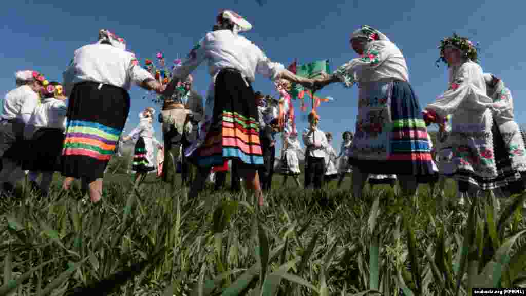 Members of the Mizhrechcha folk ensemble perform a circle dance in a field in the village of Pahost.