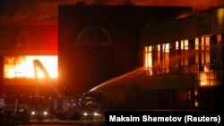 Firefighters work to extinguish a fire at the Sindika shopping center on the outskirts of Moscow.