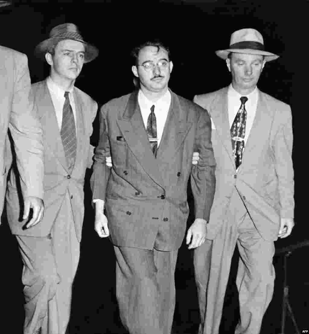 FBI agents lead Julius Rosenberg away shortly after his arrest. His wife&#39;s brother, David Greenglass, had confessed to participating in a spy ring that he said included the Rosenbergs.