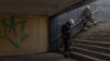 Ukrainian rescue workers who arrived at a shelling site take cover in an underground passage during an air raid alert in Kharkiv