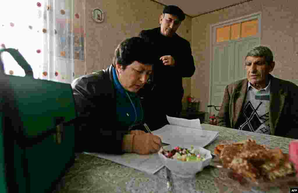 A man answers questions for census takers in the village of Madzharka in the separatist Georgian region of Abkhazia in February 2011.