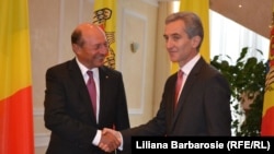 Moldovan Prime Minister Iurie Leanca (right) greets Romanian President Traian Basescu in Chisinau on July 17.