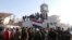 Government soldiers and civilians gather as they place the Syrian national flag on a truck in Qusayr on June 5.