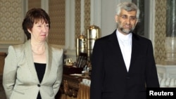 Iranian chief nuclear negotiator Said Jalili (right) and EU foreign-policy chief Catherine Ashton arrive for nuclear talks in Istanbul.