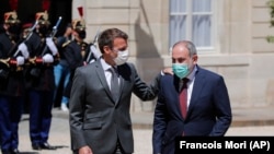 FRANCE -- French President Emmanuel Macron, left, welcomes Armenian acting Prime Minister Nikol Pashinian before a working lunch at the Elysee Palace in Paris, June 1, 2021