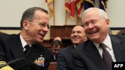 U.S. Defense Secretary Robert Gates (right) and Admiral Mike Mullen share a laugh during a House Armed Services Committee hearing in Washington on February 16.