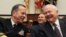 U.S. Defense Secretary Robert Gates (right) and Admiral Mike Mullen share a laugh during a House Armed Services Committee hearing in Washington on February 16.