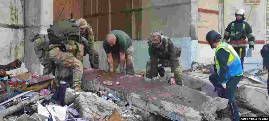 Rescuers attempt to lift a concrete panel of a shattered apartment that appears to be covered in blood.&nbsp; At least five Russian glide bombs were reported to have been used in the strikes.&nbsp; &nbsp;