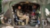 Ukrainian soldiers sit in their armored personnel carrier in Ukraine's Sumy region on August 14, after returning from Russia's Kursk region. 