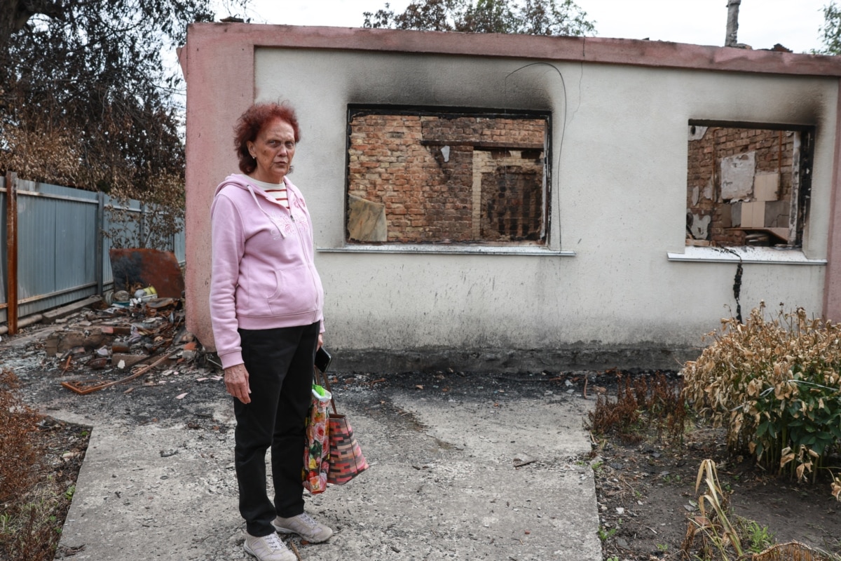 Наталія стоїть біля свого згорілого будинку. Жінка чекає на комісію, яка має визначити його долю. У руках вона тримає всі речі, які вціліли – це документи, які вона завжди брала з собою в укриття).<br>«Ніхто з нас не знає, що з нами буде. От ми самі в здогадках, немає де жити, немає нічого, – каже жінка. – Найбільше допомоги ми за цей тиждень отримали від волонтерів: їжу, одяг, – запитують що потрібно, і привозять, а від державних органів нічого»