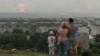 People watch the initial explosions on August 5.