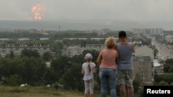 People watch the initial explosions on August 5.