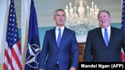 U.S. Secretary of State Mike Pompeo (right) and NATO Secretary-General Jens Stoltenberg make their way into the treaty room ahead of a bilateral meeting at the State Department in Washington, September 13, 2018