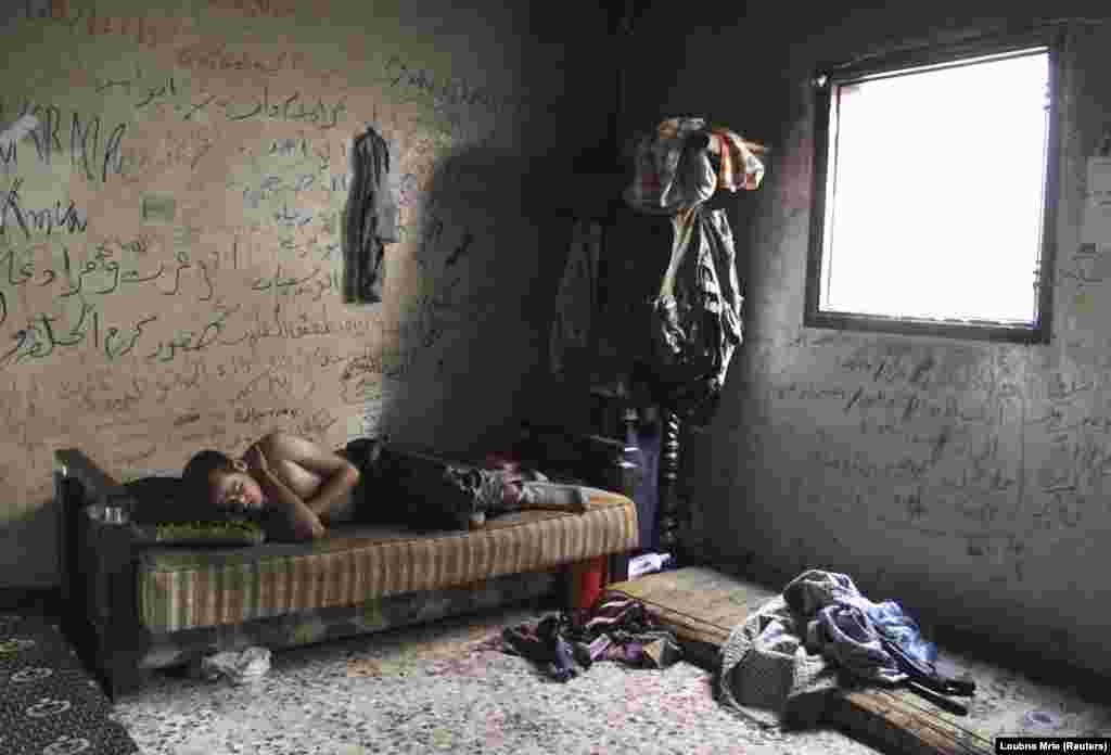 A Free Syrian Army fighter rests inside a house in Aleppo&#39;s Karm al-Jabal district. (Reuters/Loubna Mrie)