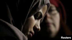 A Muslim woman in Seattle listens during a protest held in response to U.S. President Donald Trump's travel ban on January 29.