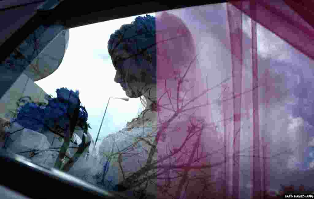 Sundus Garis, a 16-year-old displaced Iraqi woman from the Yazidi community, is pictured through a car window during her wedding ceremony in the northernwestern Iraqi Kurdish city of Dohuk, near the border with Turkey. (AFP/Safin Hamed)