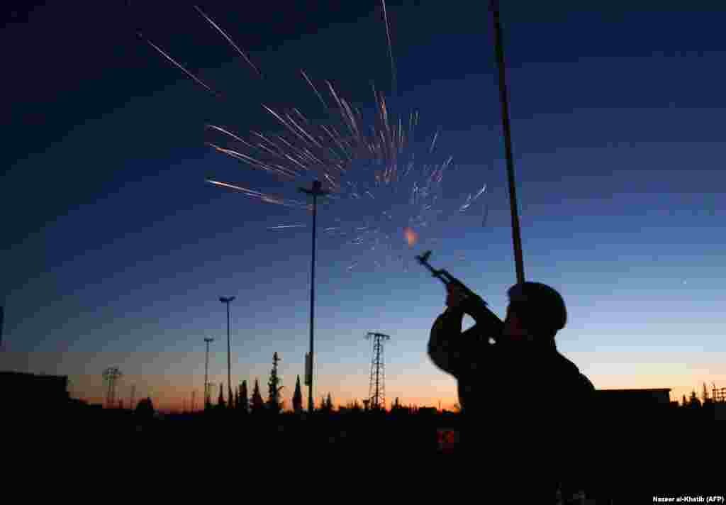 &nbsp;A Turkish-backed rebel fighter fires ammunition as buses arrive at a checkpoint near the northern Syrian town of Al-Bab after transporting evacuated Jaish al-Islam fighters and their families from the besieged rebel stronghold of Douma. (AFP/Nazeer al-Khatib)