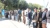 Afghan voters wait in a queue to cast their ballots in the northern Kunduz Province on October 20.