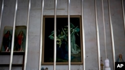 Catholic religious paintings and figures are displayed behind bars at an underground Catholic church in south China's Guangdong province. (file photo)