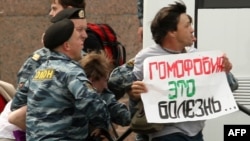 Russian police arrest a gay-rights activist holding a poster reading "Homophobia is a disease" during a banned gay-pride rally in St. Petersburg in June.
