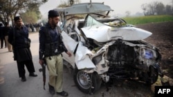 Pakistani police examine the wreckage of a bomb-disposal vehicle after a roadside bomb explosion on the outskirts of Peshawar on December 16.