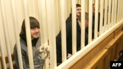 Suspects in the murder trial of journalist Anna Politkovskaya sit in the defendants' cage in a Moscow court.