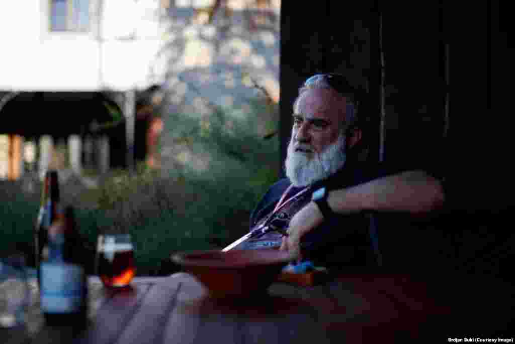 These are the photographs of Srdjan Suki (pictured) who began his career covering the conflicts of the former Yugoslavia, and joined the European Pressphoto Agency (epa) in 1993. His death on September 24 sparked an outpouring of tributes to a man dubbed a “legend” by fellow photographers. In a statement to RFE/RL about Suki’s death, epa described him as "a larger than life character that lit up any room he entered. He was a well-known name on the photography circuit and was passionate about life and photojournalism, having covered everything from the Balkan conflicts, the war in Iraq, the World Cup and many other sporting events around the world… The tributes have been pouring in from around the world from colleagues who have been inspired by him and it's a testament to the impact he had on everyone he worked with." 